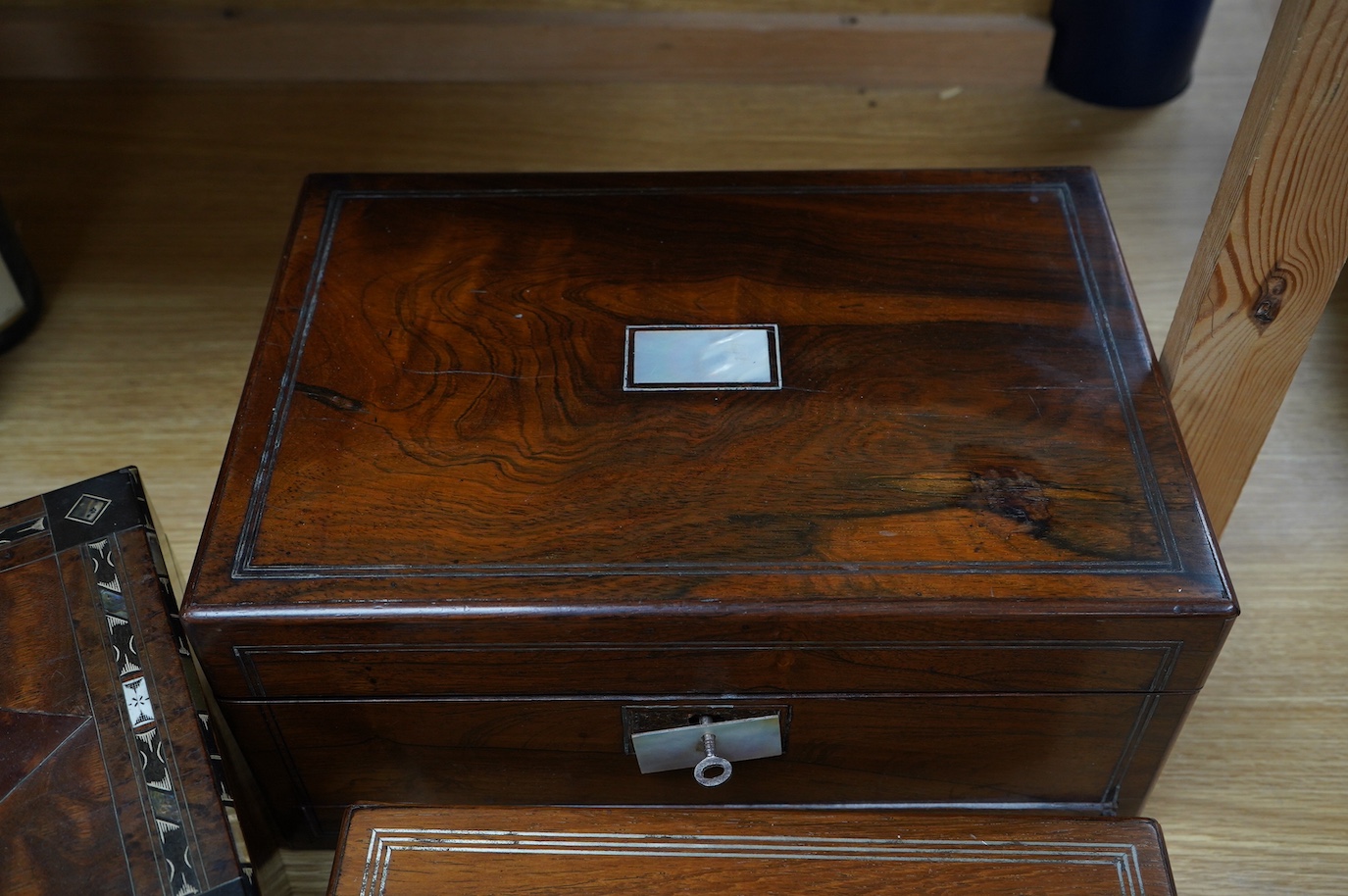 Three 19th century vanity and sewing boxes with fitted interiors to include a mother of pearl inlaid example with glass bottles, jars and mirror, largest 35cm wide. Condition - fair, some losses